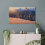 Beautiful Sunrise above Mountains with Pine Trees covered in Snow Canvas Print